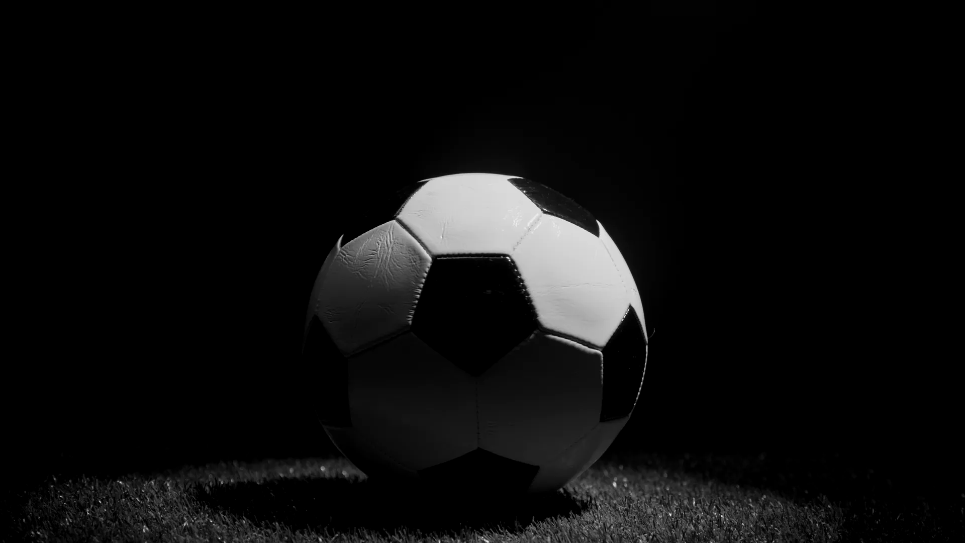 Fußball im Scheinwerferlicht auf dem Rasen